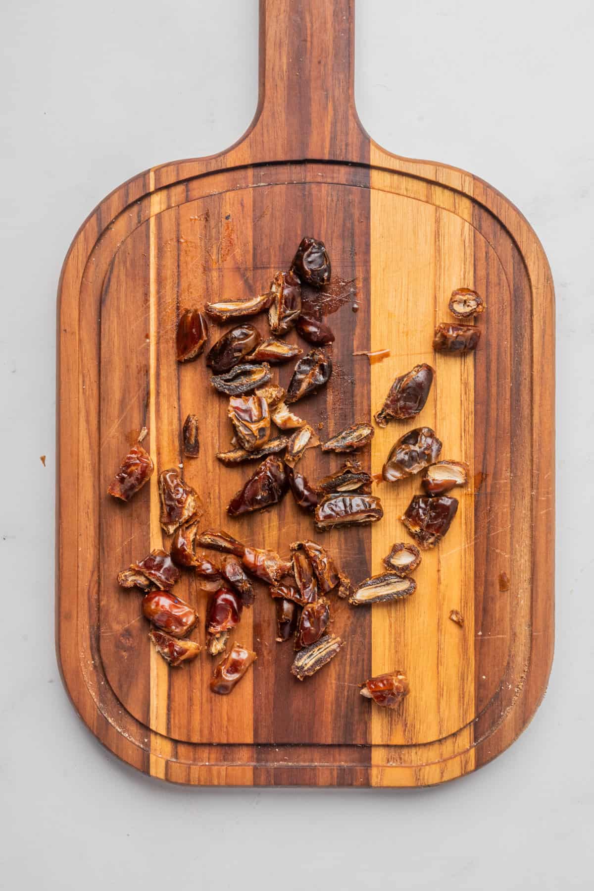 An image of frozen dates on a chopping board.