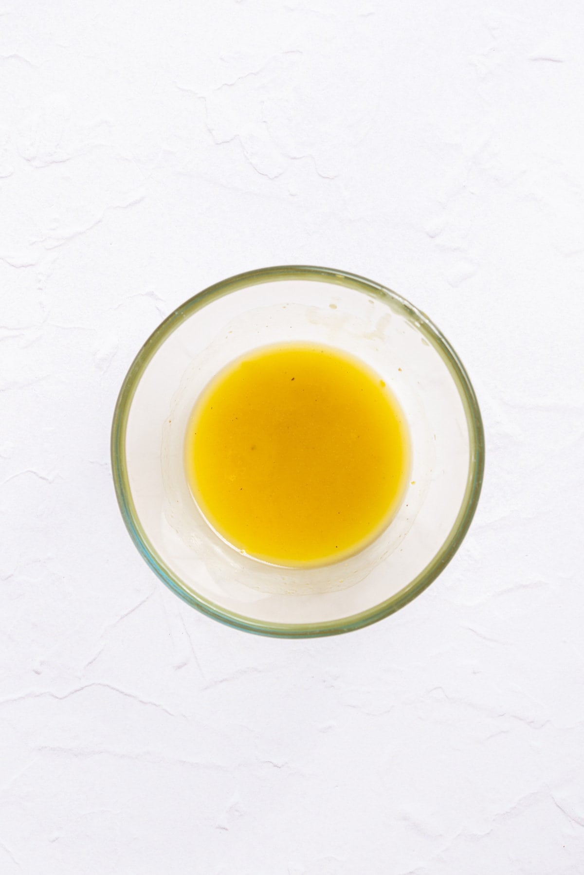 An image of a mixture of lemon juice, lemon zest, golden syrup, and olive oil