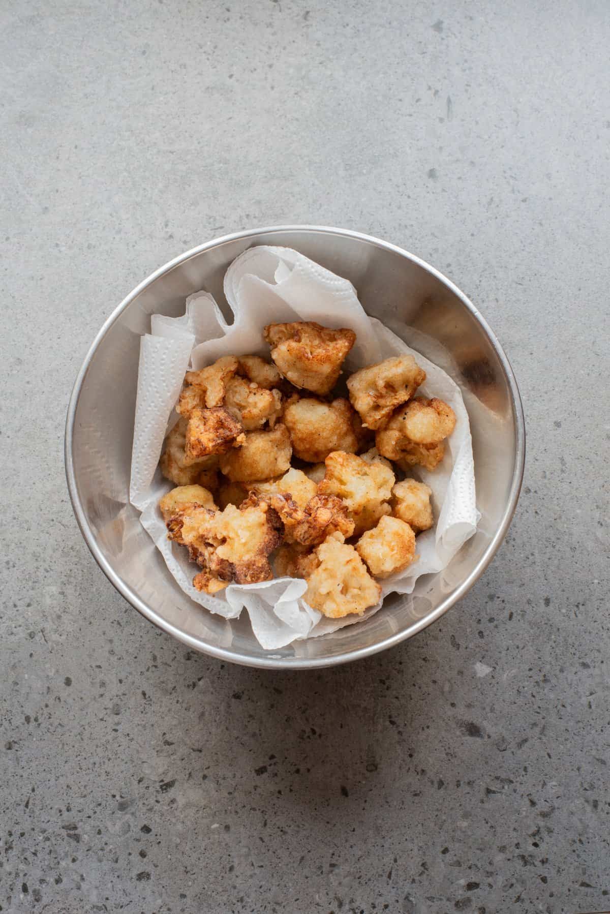 An overhead image of crispy fried cauliflower florets.