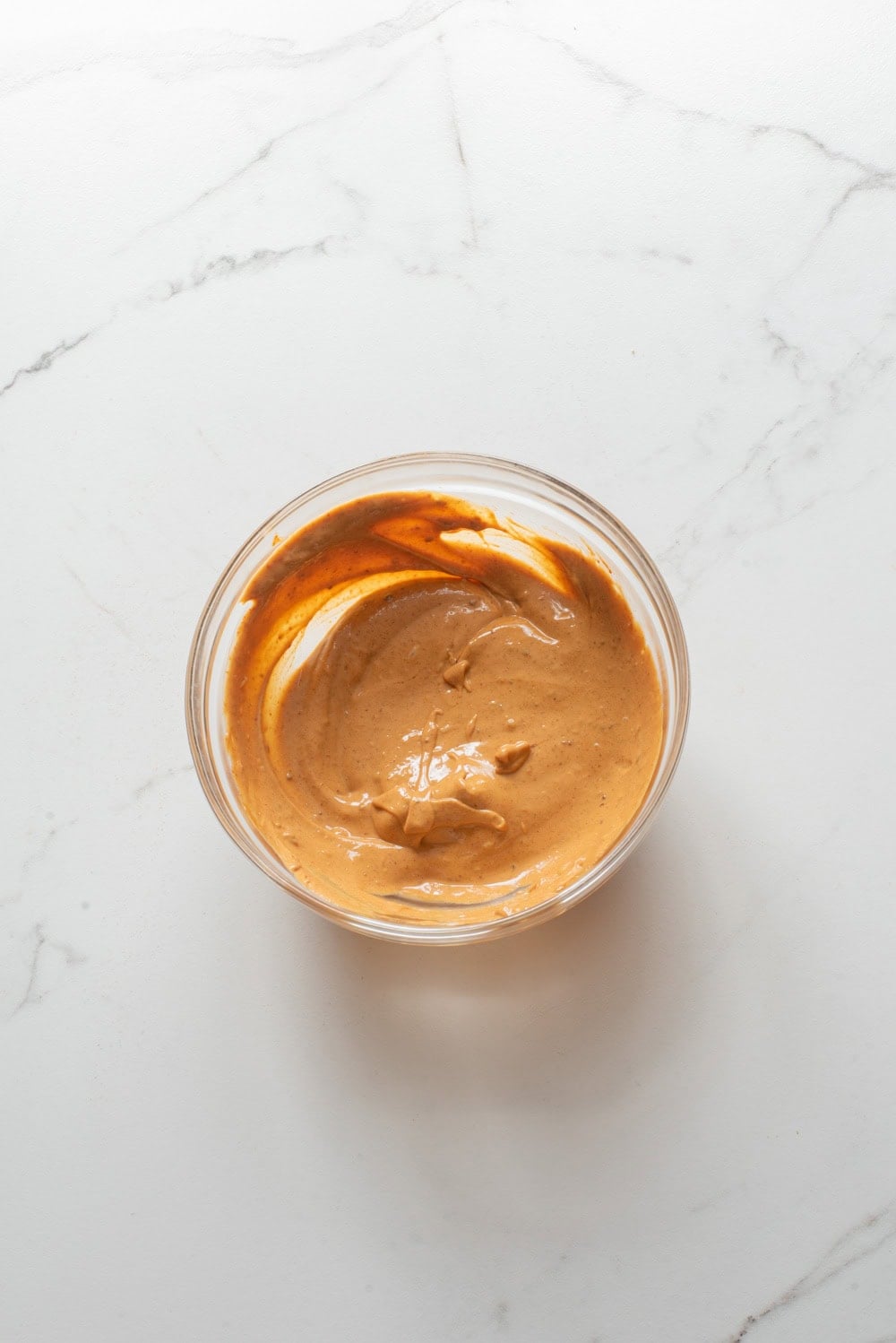 Gochujang and mayonnaise mixed together in a small bowl to make spicy mayo.