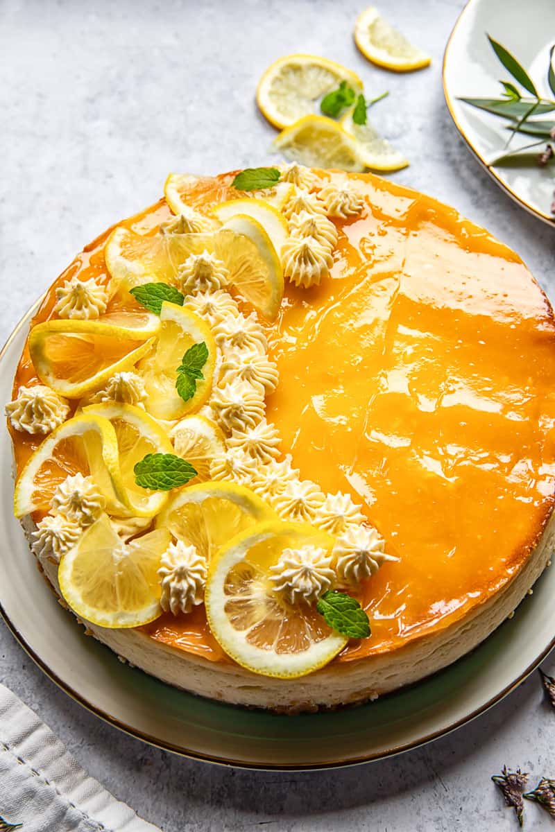 Overhead view of lemon curd cheesecake with lemon slices as decorative topping.