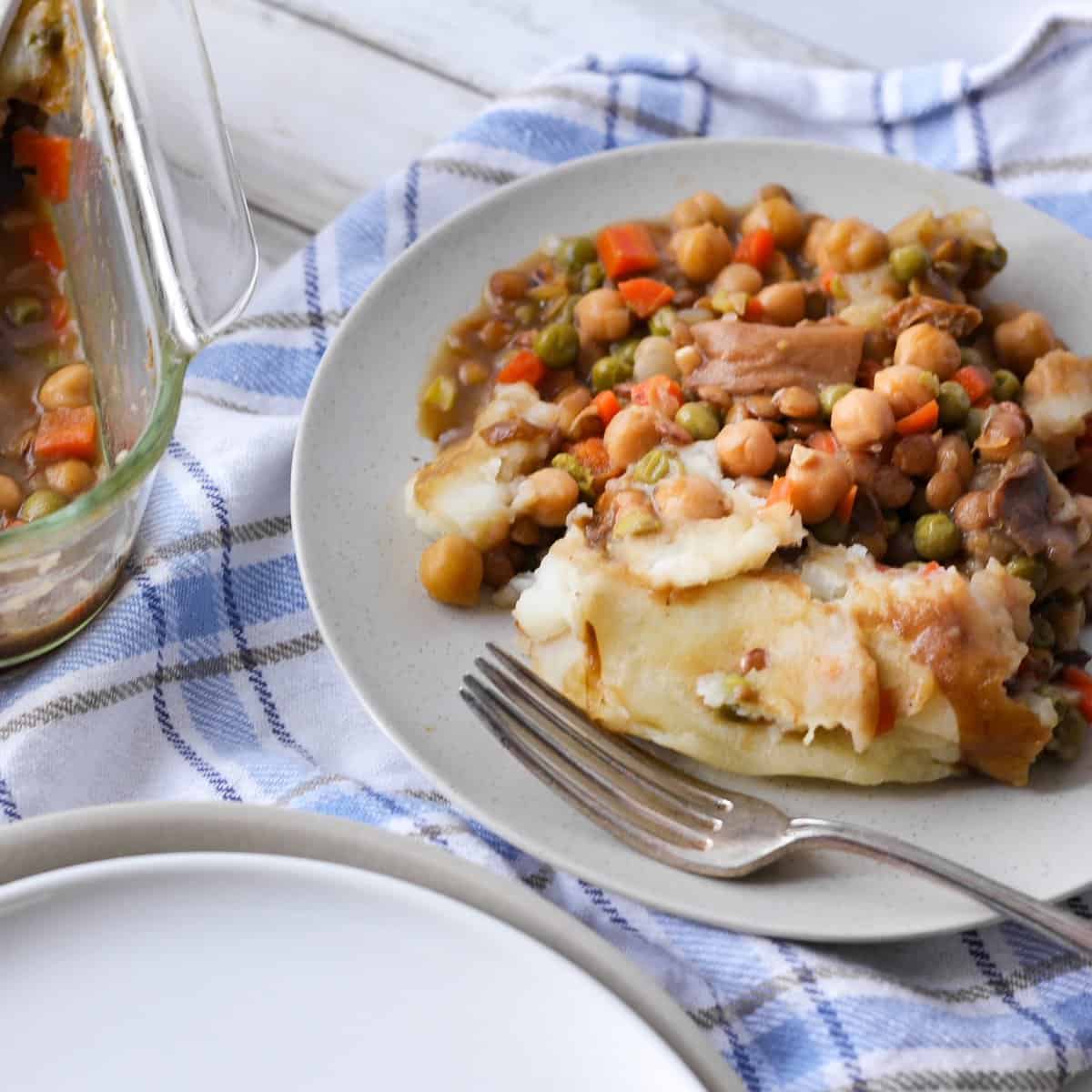 A straight view of the vegan shepherd’s pie with lentils placed on a plate.