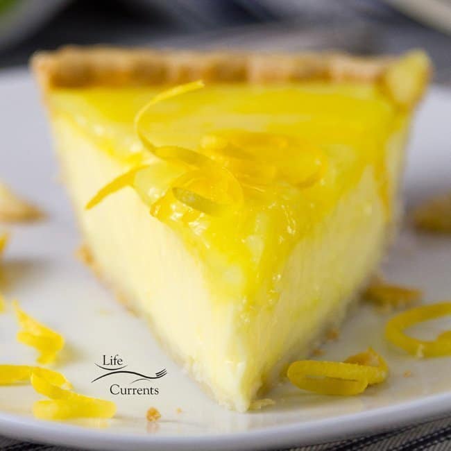 Straight view of Grandma’s lemon custard pie with lemon curd topping placed on a plate.
