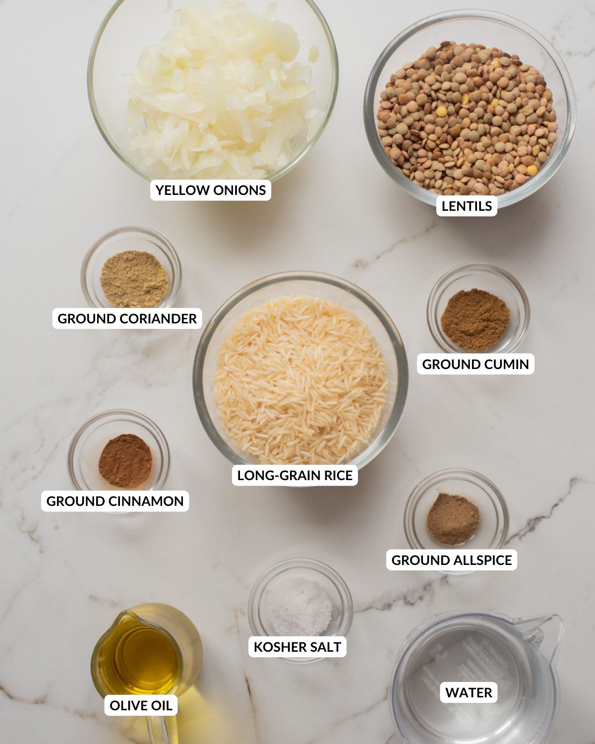Ingredients for mujaddara arranged on a marble surface.