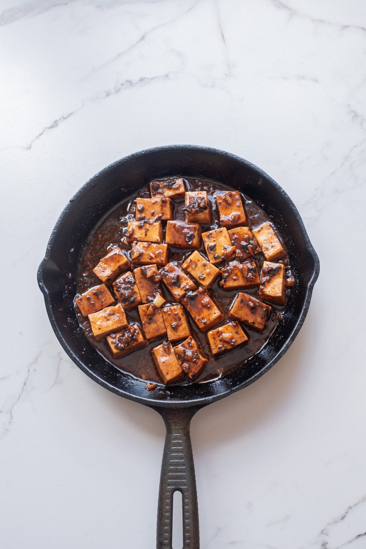 An overhead image of mapo tofu in a skillet.