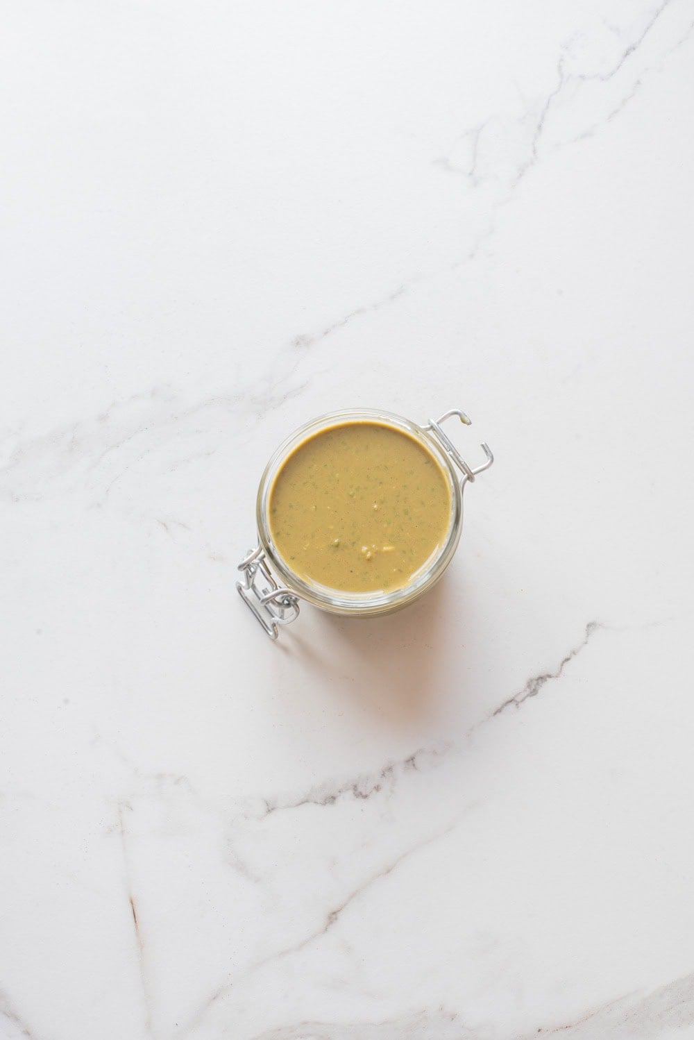 Overhead image of matcha chia overnight oats without toppings in a jar.