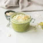 Close-up image of matcha chia overnight oats with toppings in a jar.