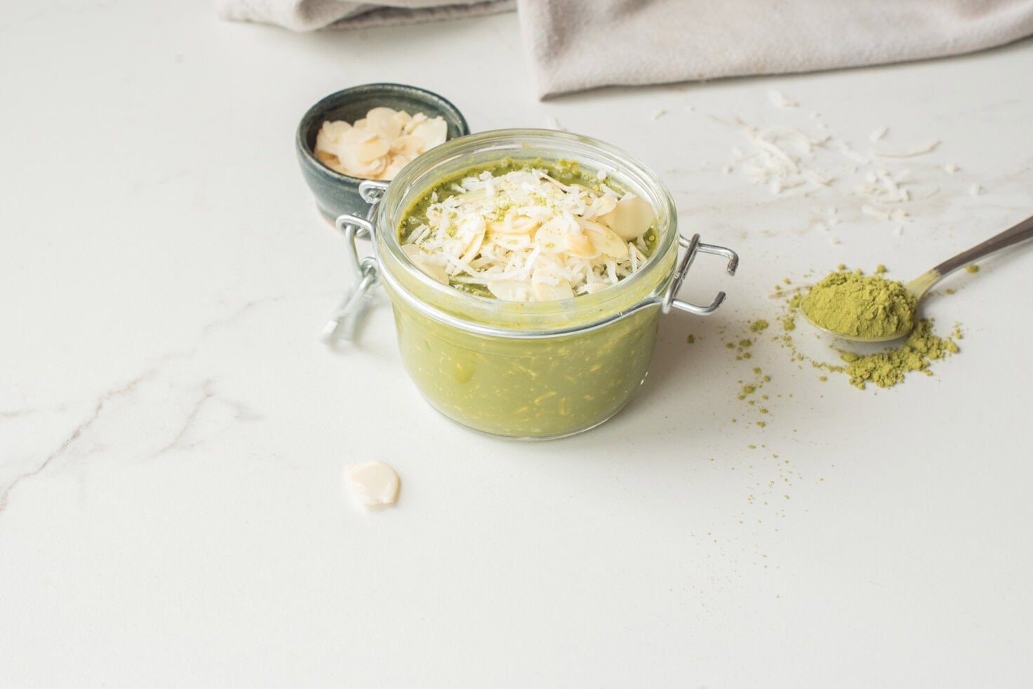 Matcha chia overnight oats with toppings in a jar.