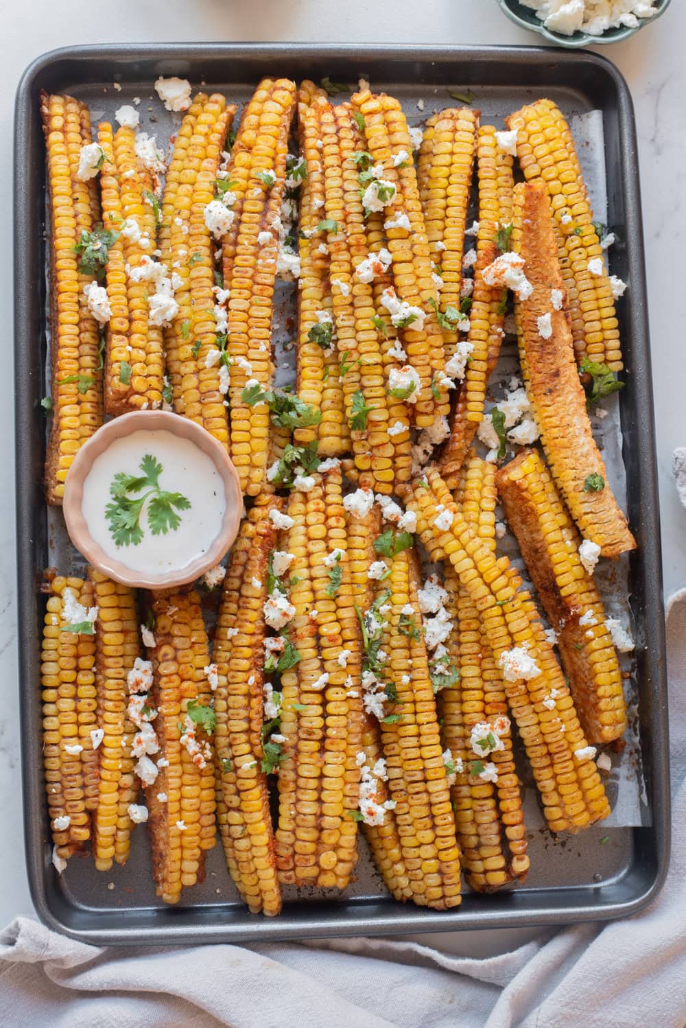 An overhead image of corn ribs on a baking sheet.
