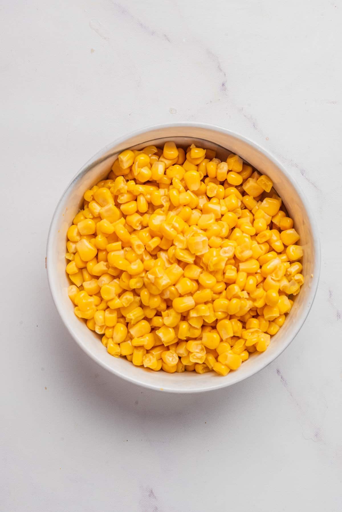 An overhead image of corn kernels in a bowl.