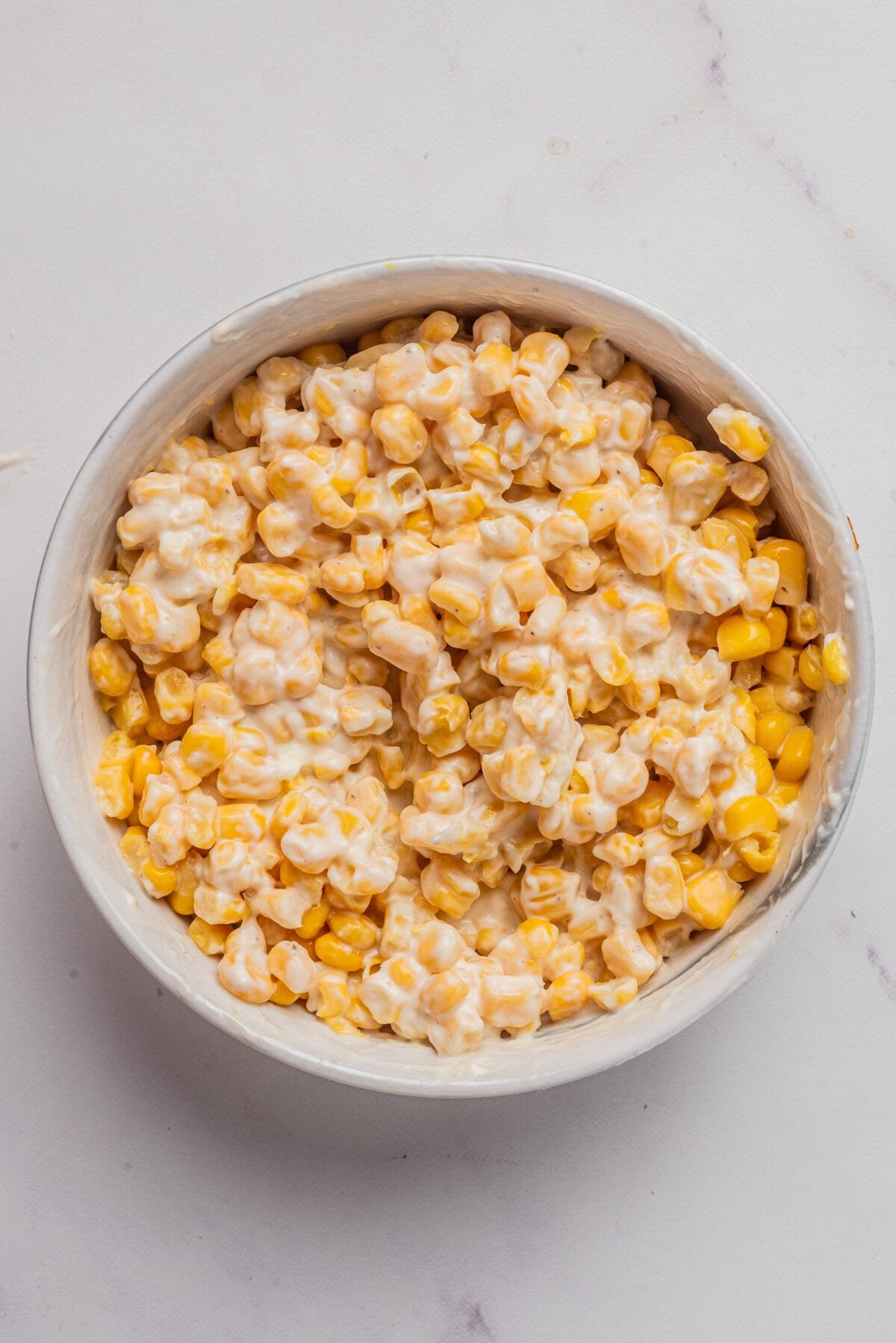 An overhead image of the corn kernels mixed with the dressing.