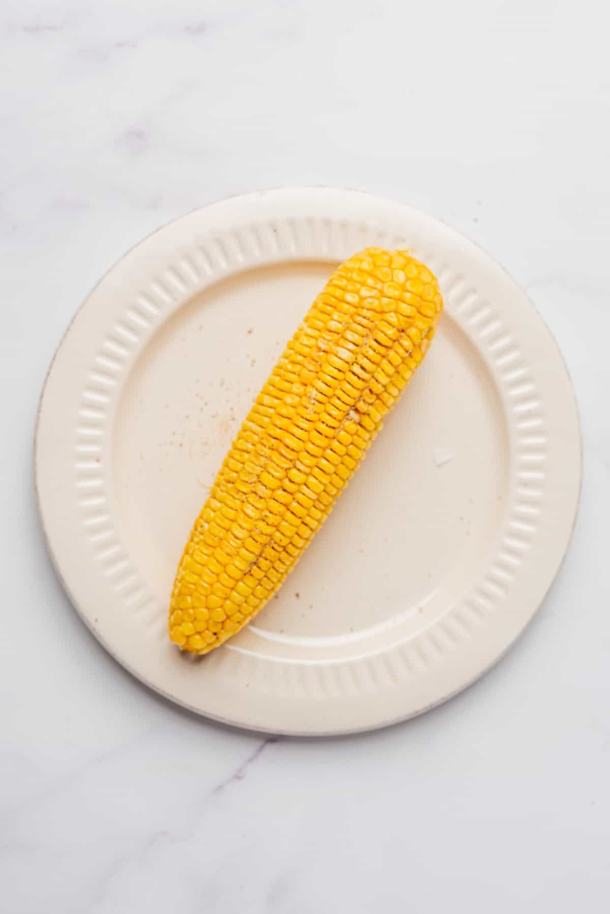 An image of a corn on a microwave-safe dish