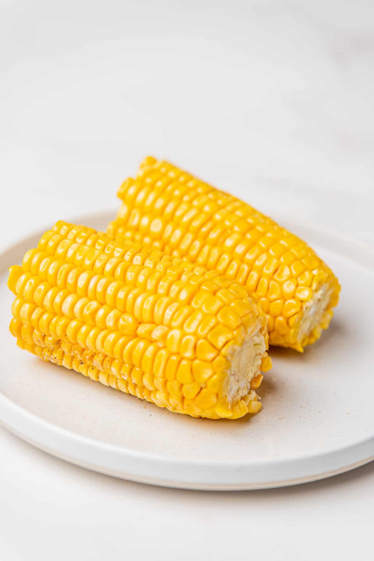 An image of a halved corn served on a plate