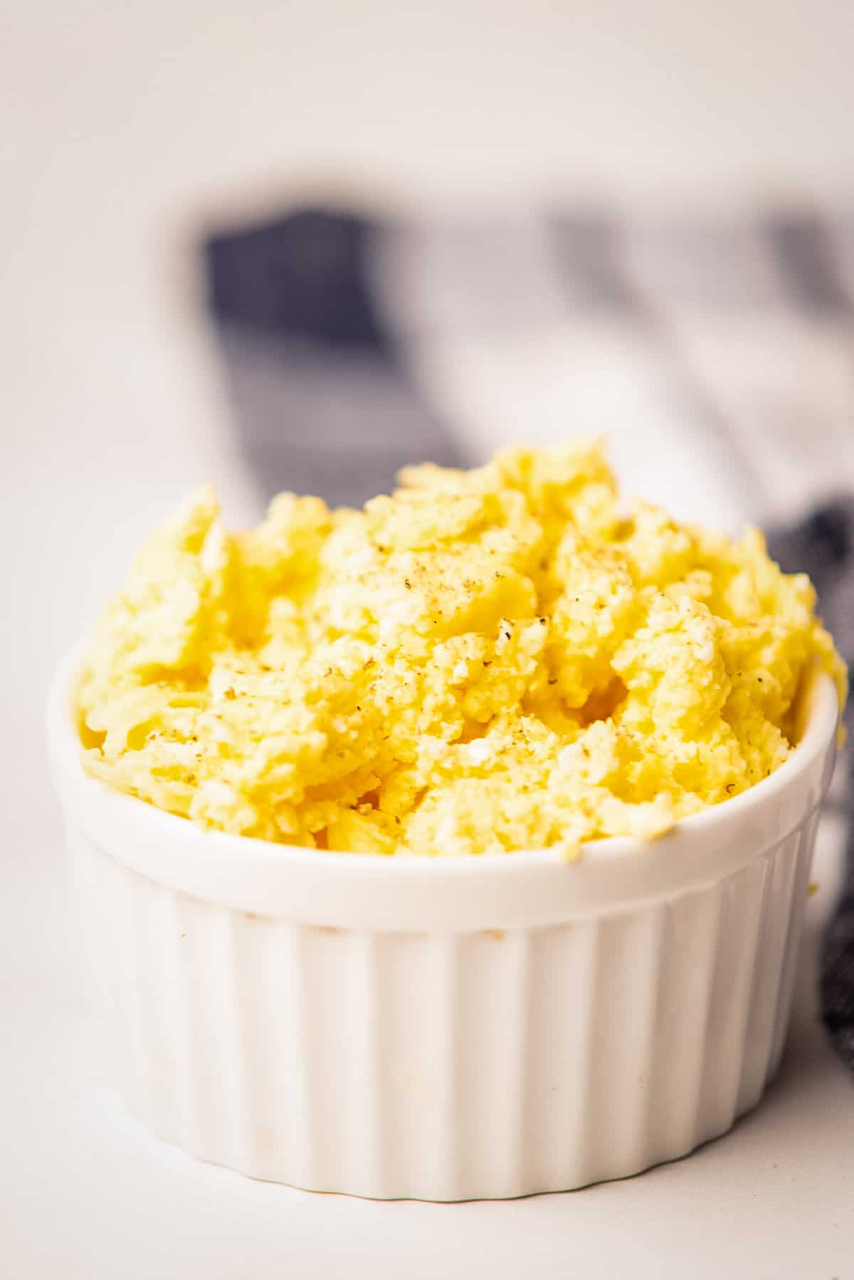 An image of microwave scrambled eggs inside a ramekin.