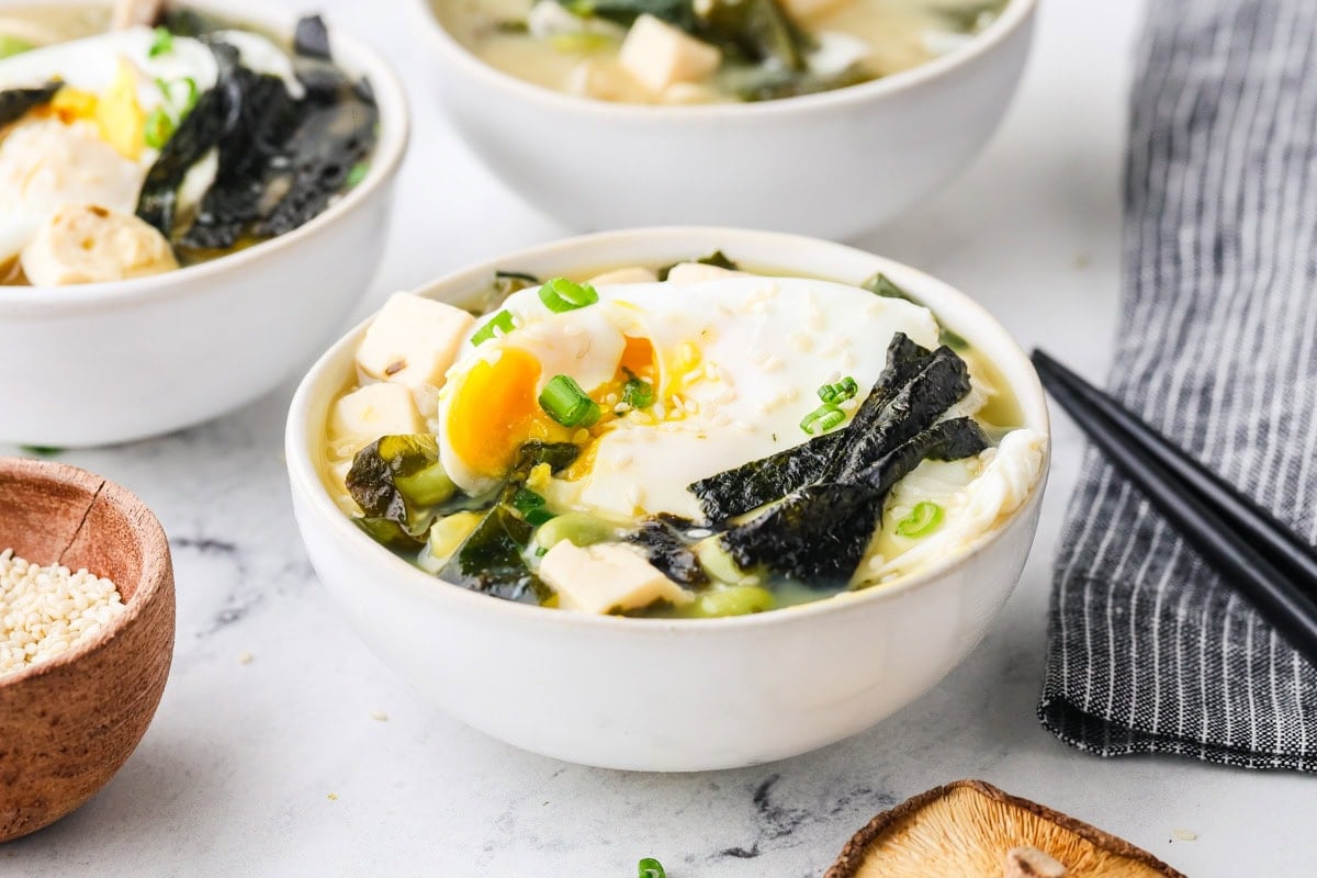 A close up image of miso soup served in a bowl.