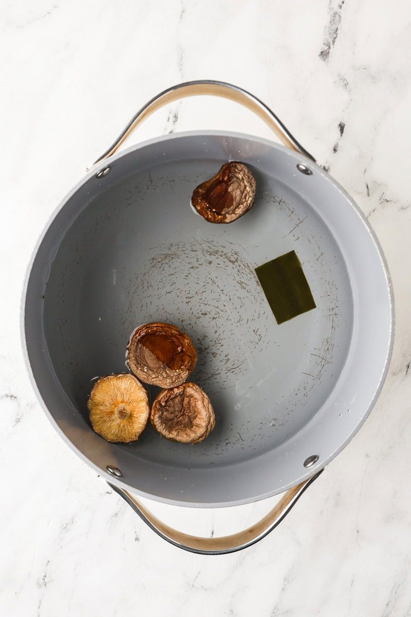 Dried shiitakes and kombu in medium pot with water.