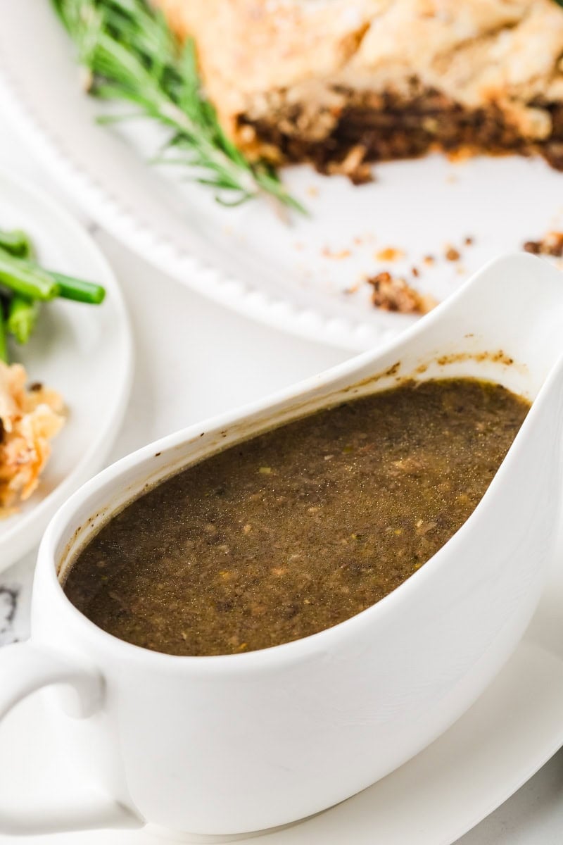 Rich vegan mushroom gravy in a white gravy boat.