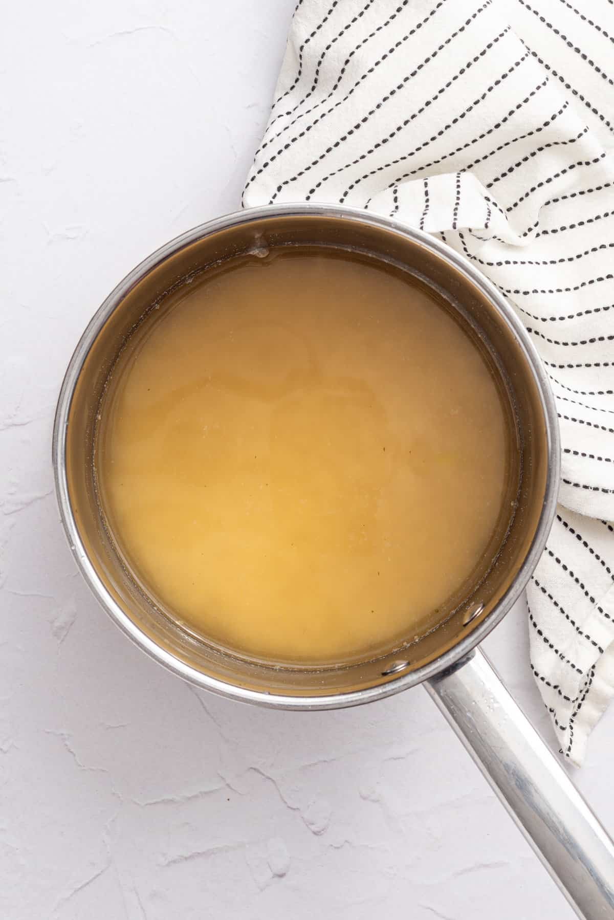 An overhead image of vegetable stock in a pot.