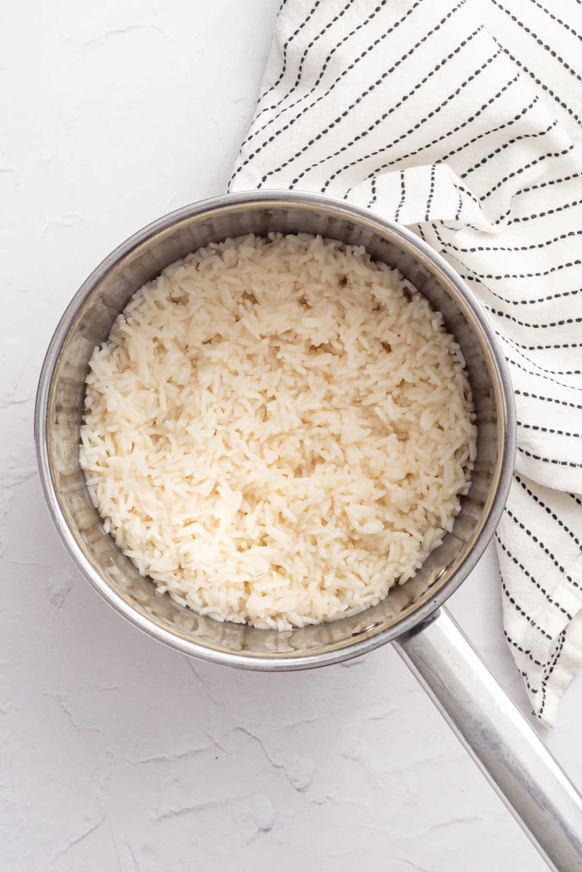 An overhead image of white rice in a pot.