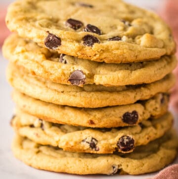Close up of stacked chocolate chip cookies.