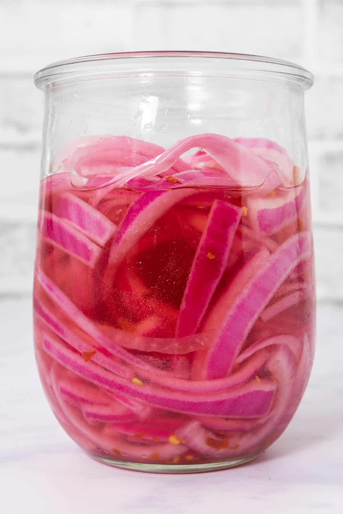 Side view of jar of pickled onions