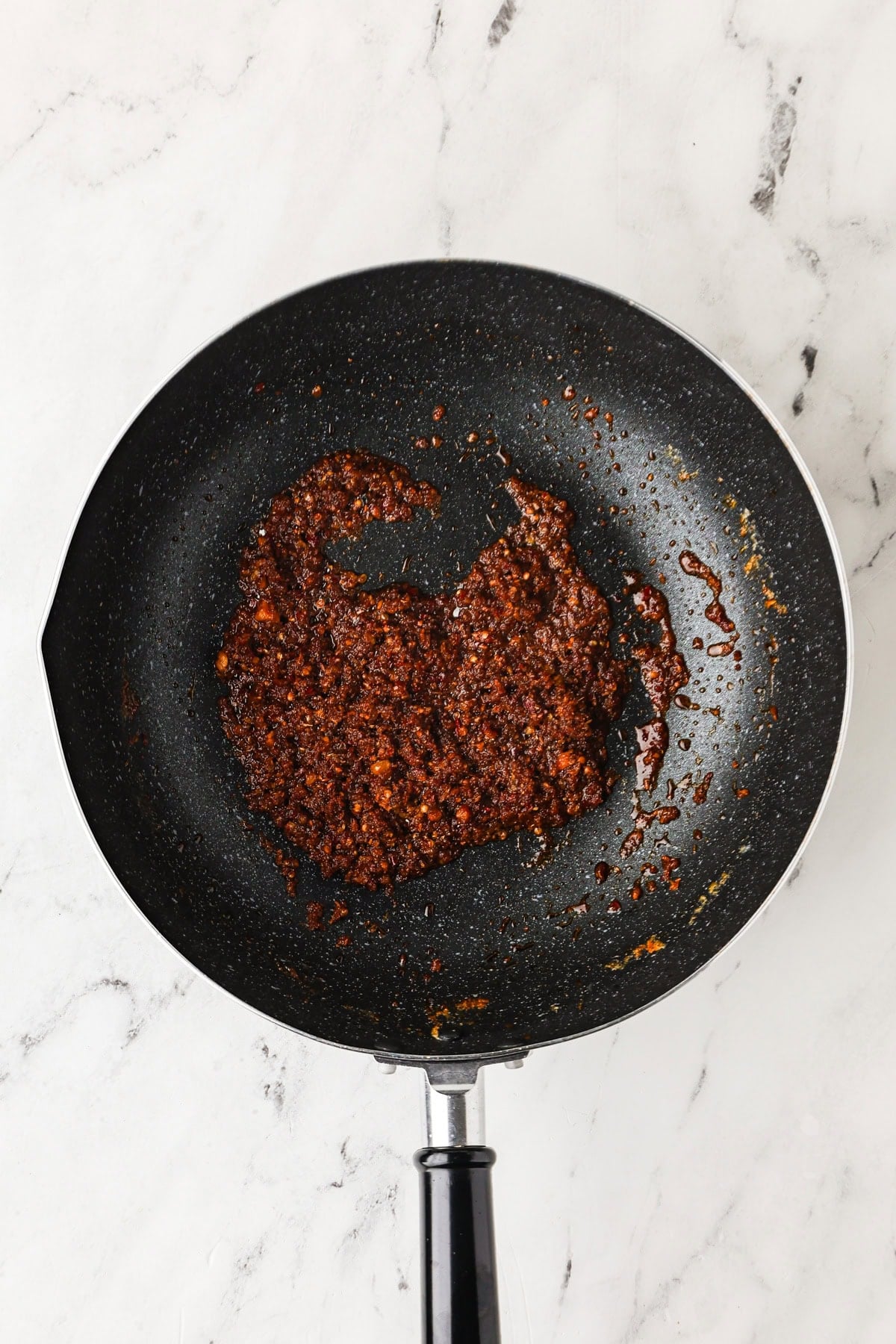 An overhead image of toasting the curry paste.