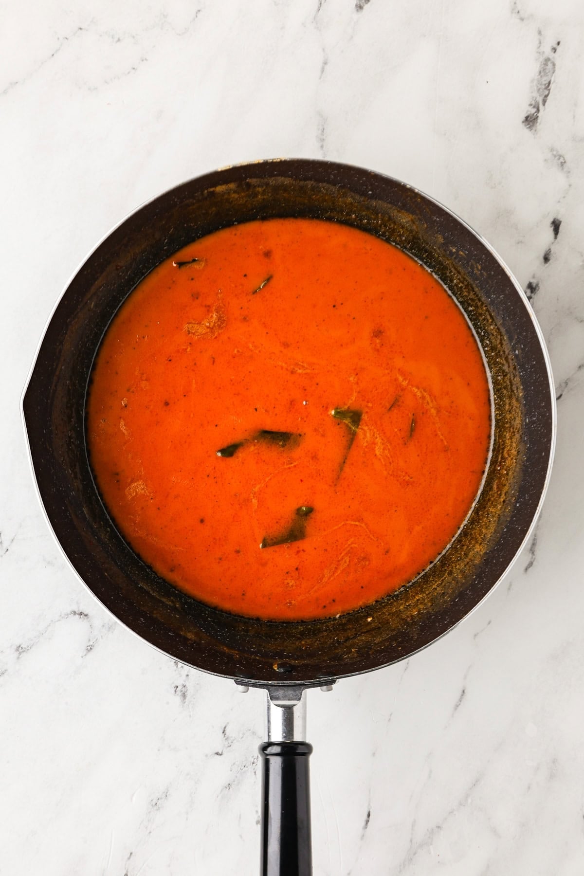 An overhead image of building the curry sauce.