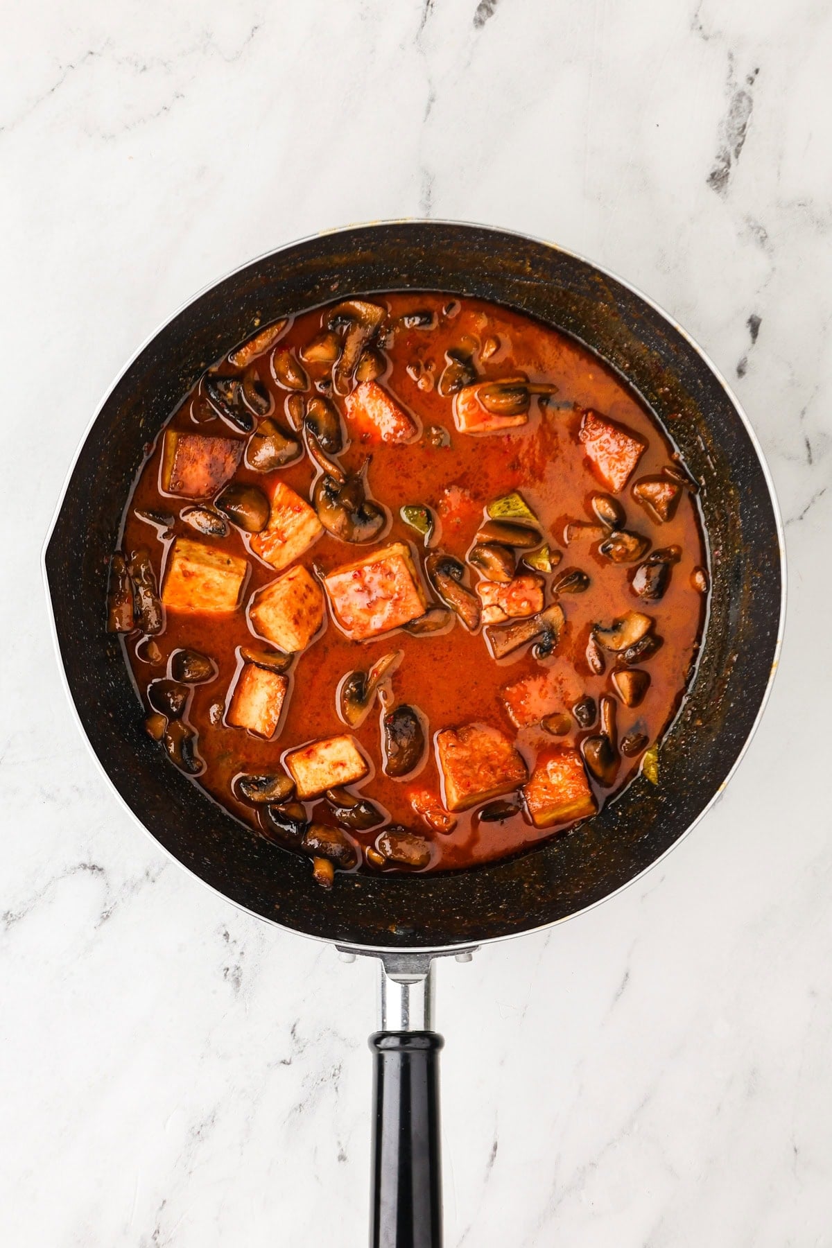 An overhead image of vegetarian panang curry in a skillet.