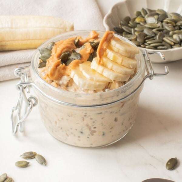 A close up image of peanut butter banana overnight oats in a mason jar.