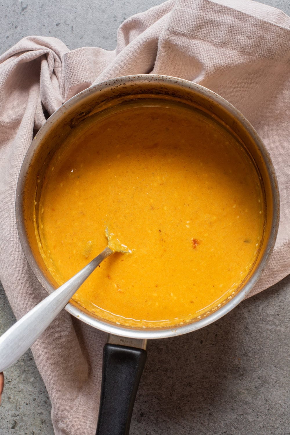 Overhead image of peanut sauce in a pan.
