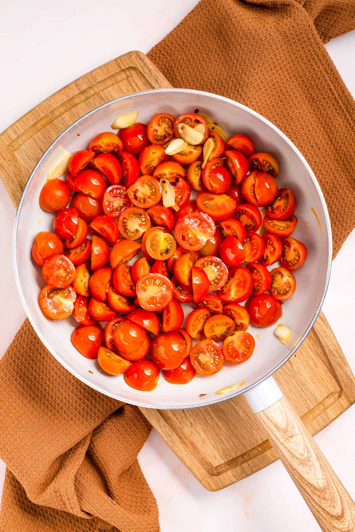 Overhead view of cherry tomatoes in a skillet.