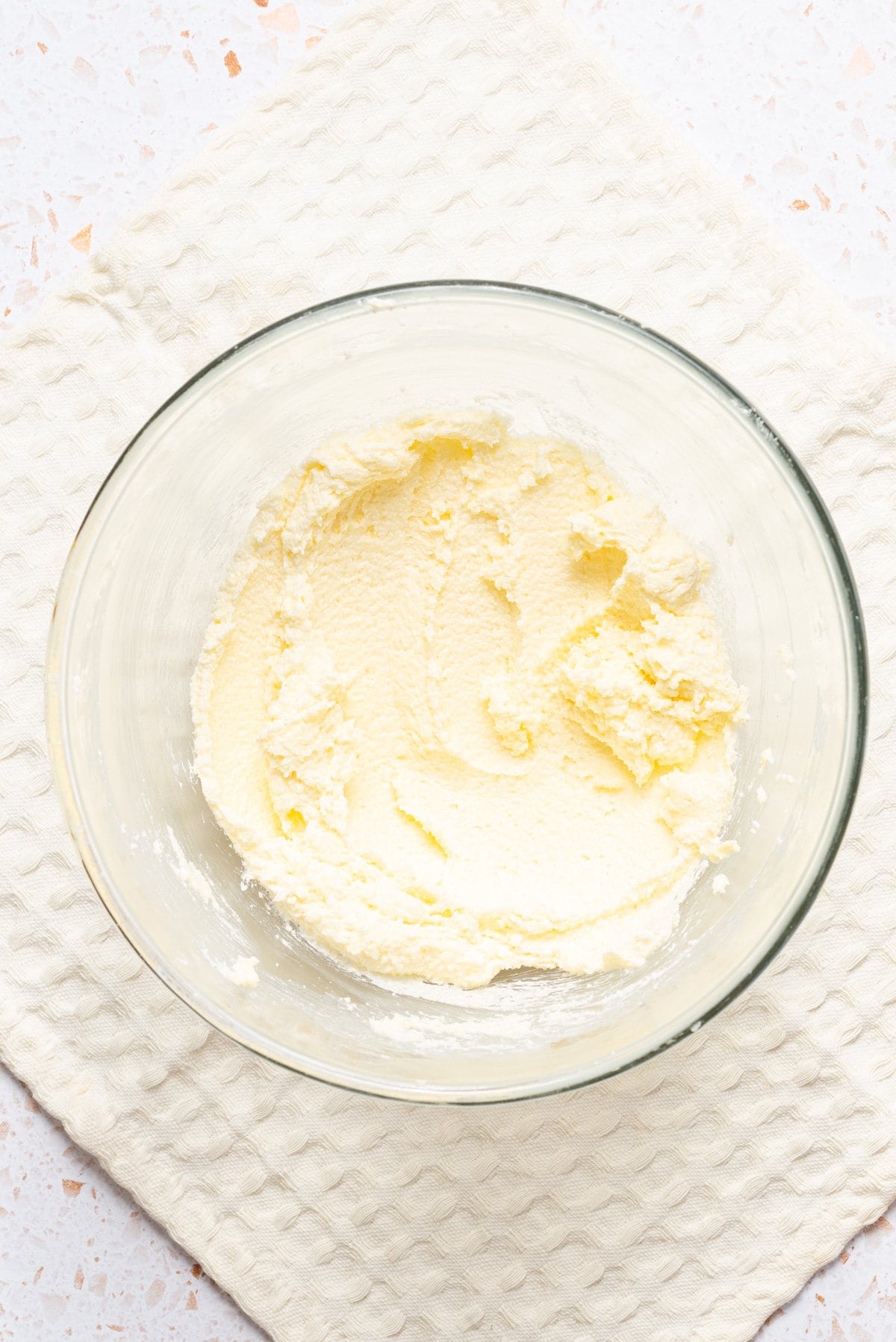 An image of creamy butter and sugar in a bowl.