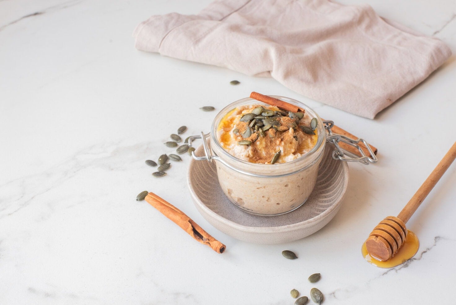 Pumpkin pie overnight oats with toppings in a jar.