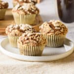 Close up image of pumpkin streusel muffins on a white plate.