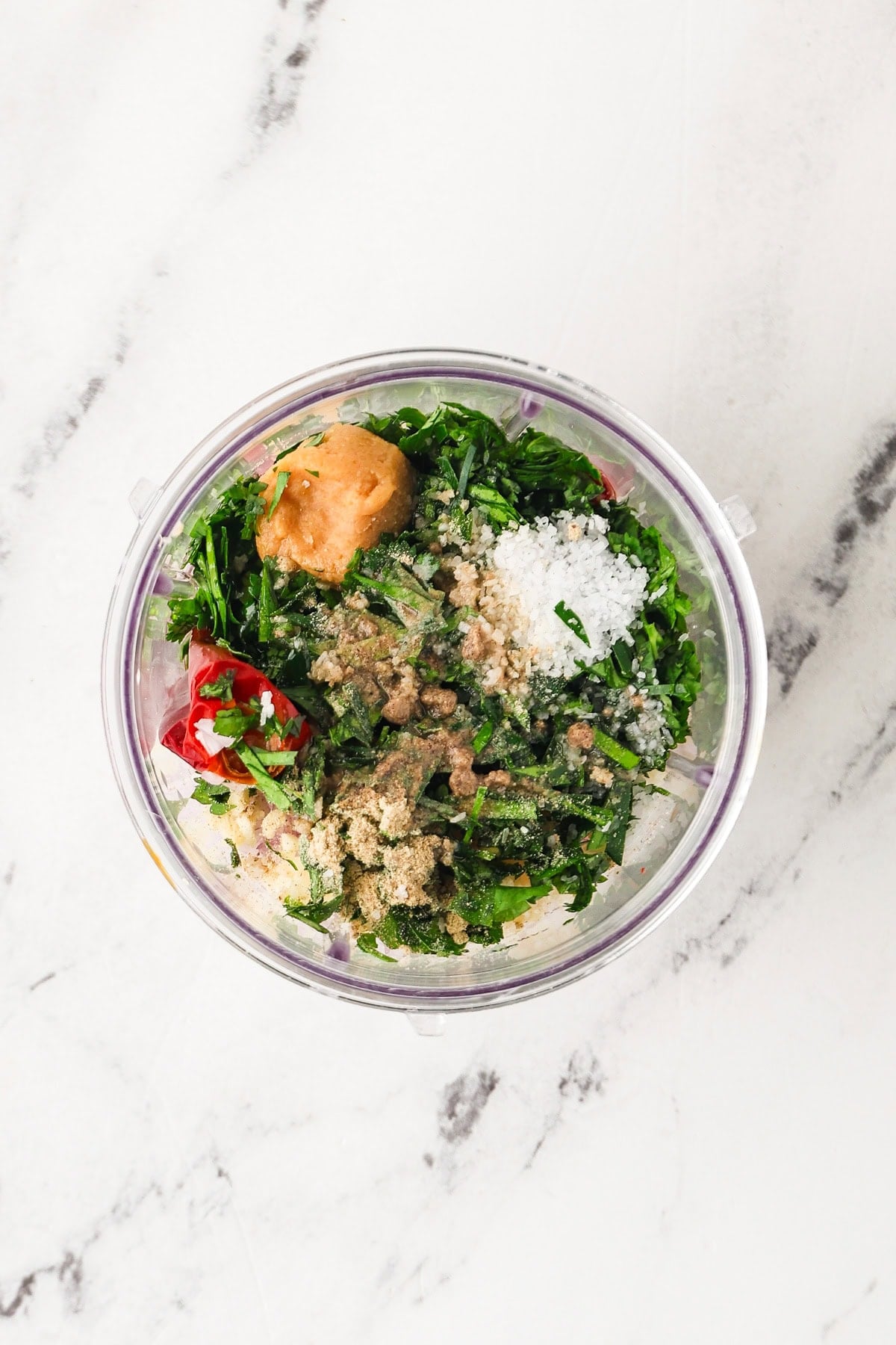 Overhead image of ingredients for vegan Thai red curry paste in a blender.