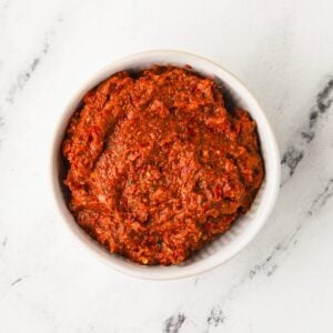 Overhead image of vegan Thai red curry paste in a bowl.