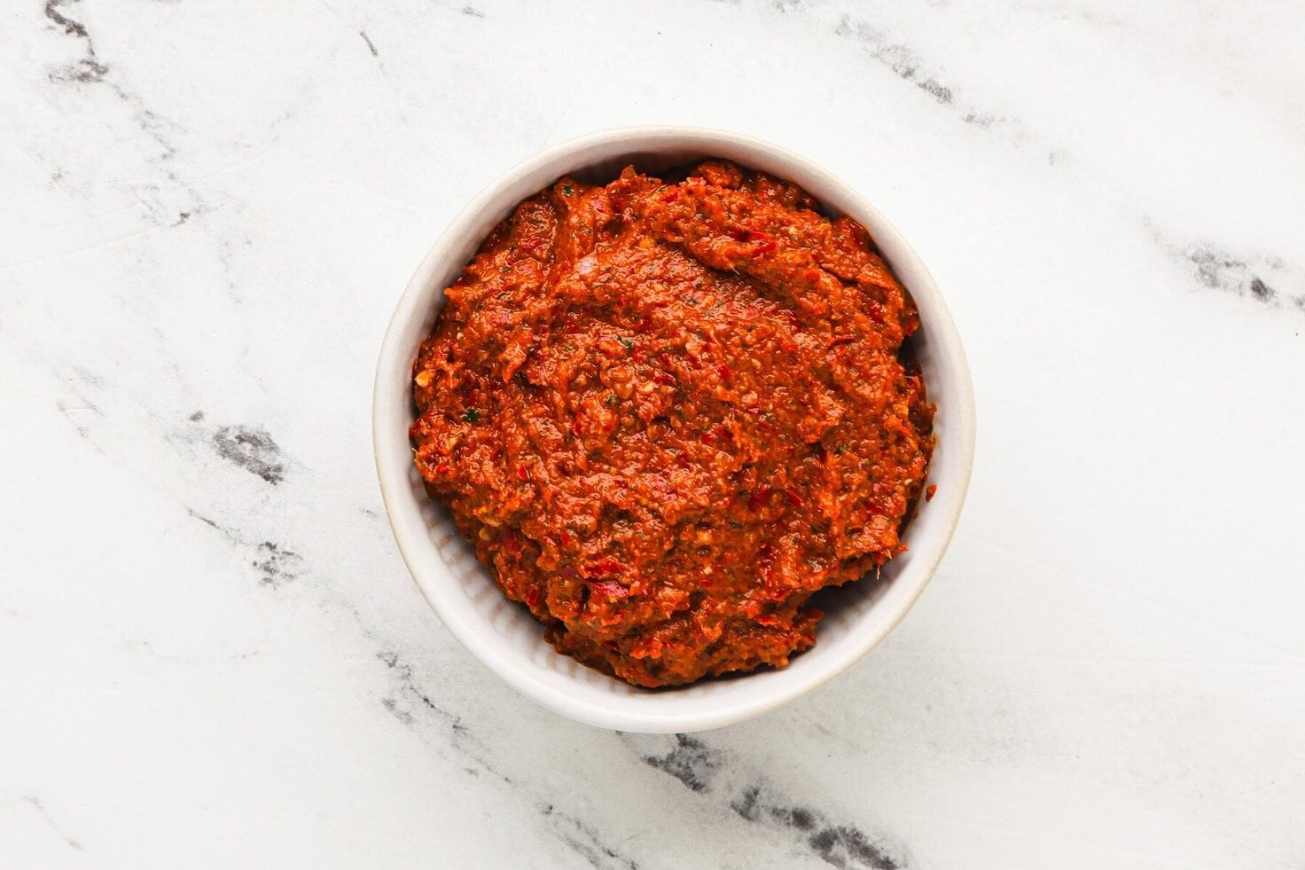 Overhead image of vegan Thai red curry paste in a bowl.