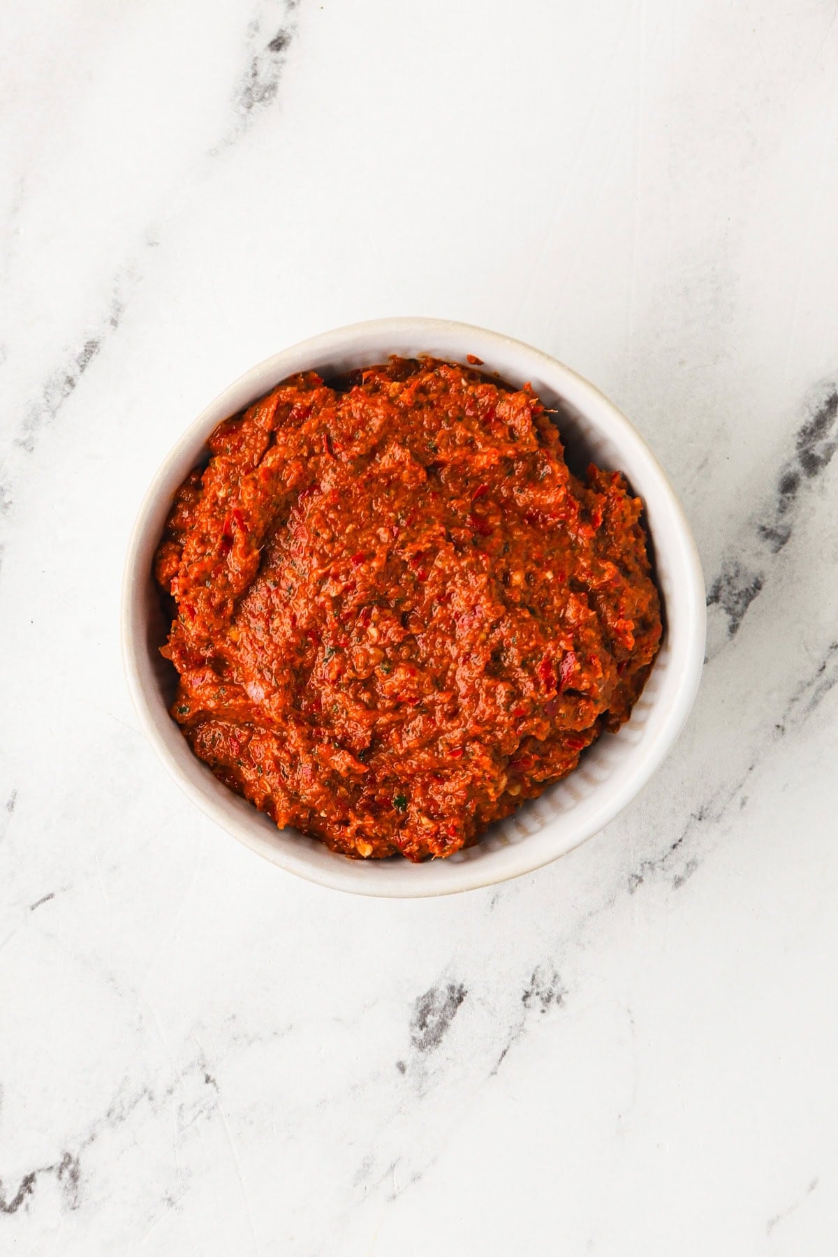 Overhead image of vegan Thai red curry paste in a bowl.