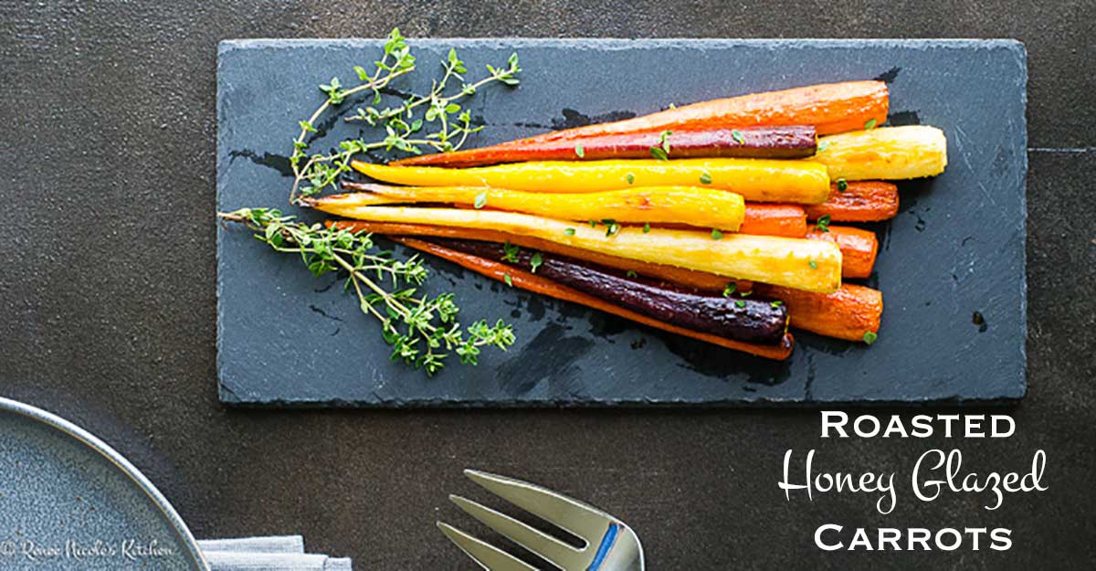 Overhead view of roasted honey glazed carrots placed on a slated board.