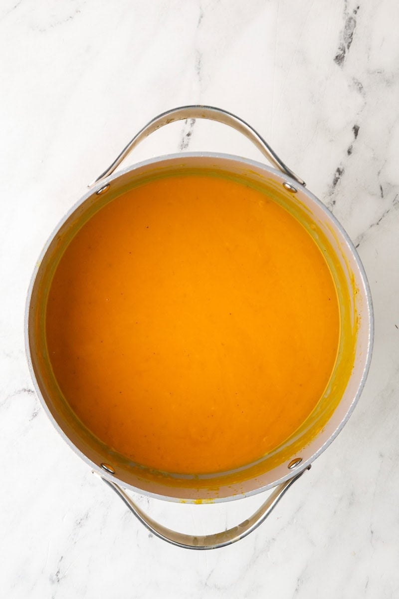 Smooth blended roasted honeynut squash soup in a pot.