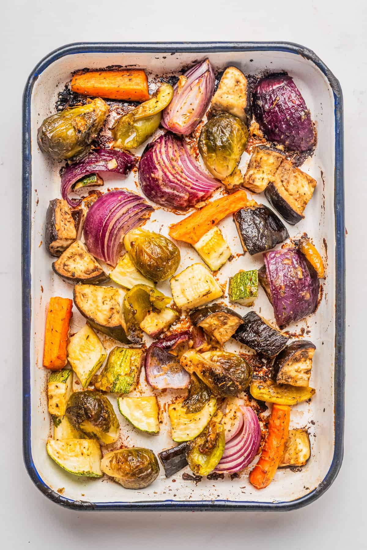 An overhead image of roasted vegetable salad on a baking dish.