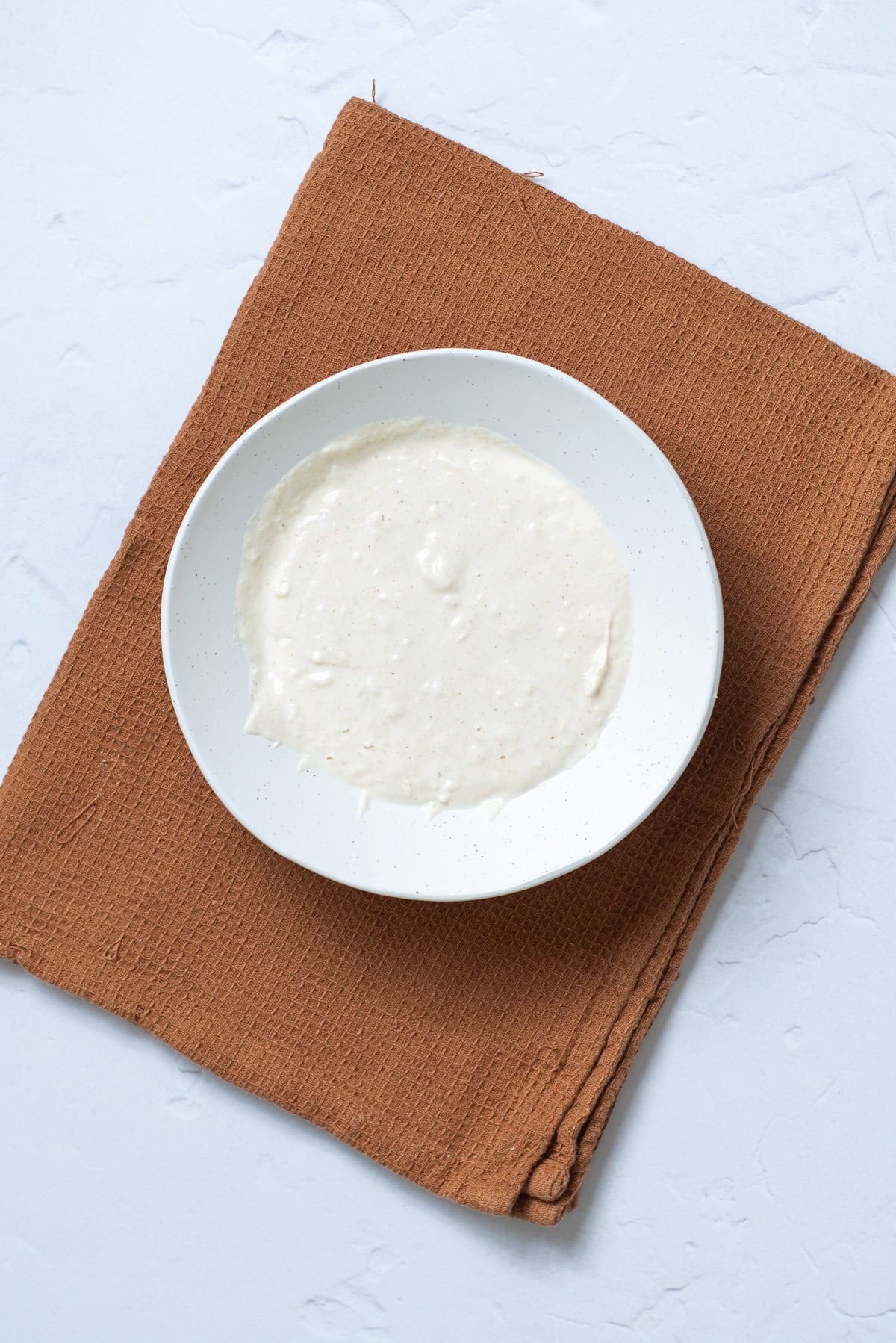 An overhead image of making the sauce in a bowl.