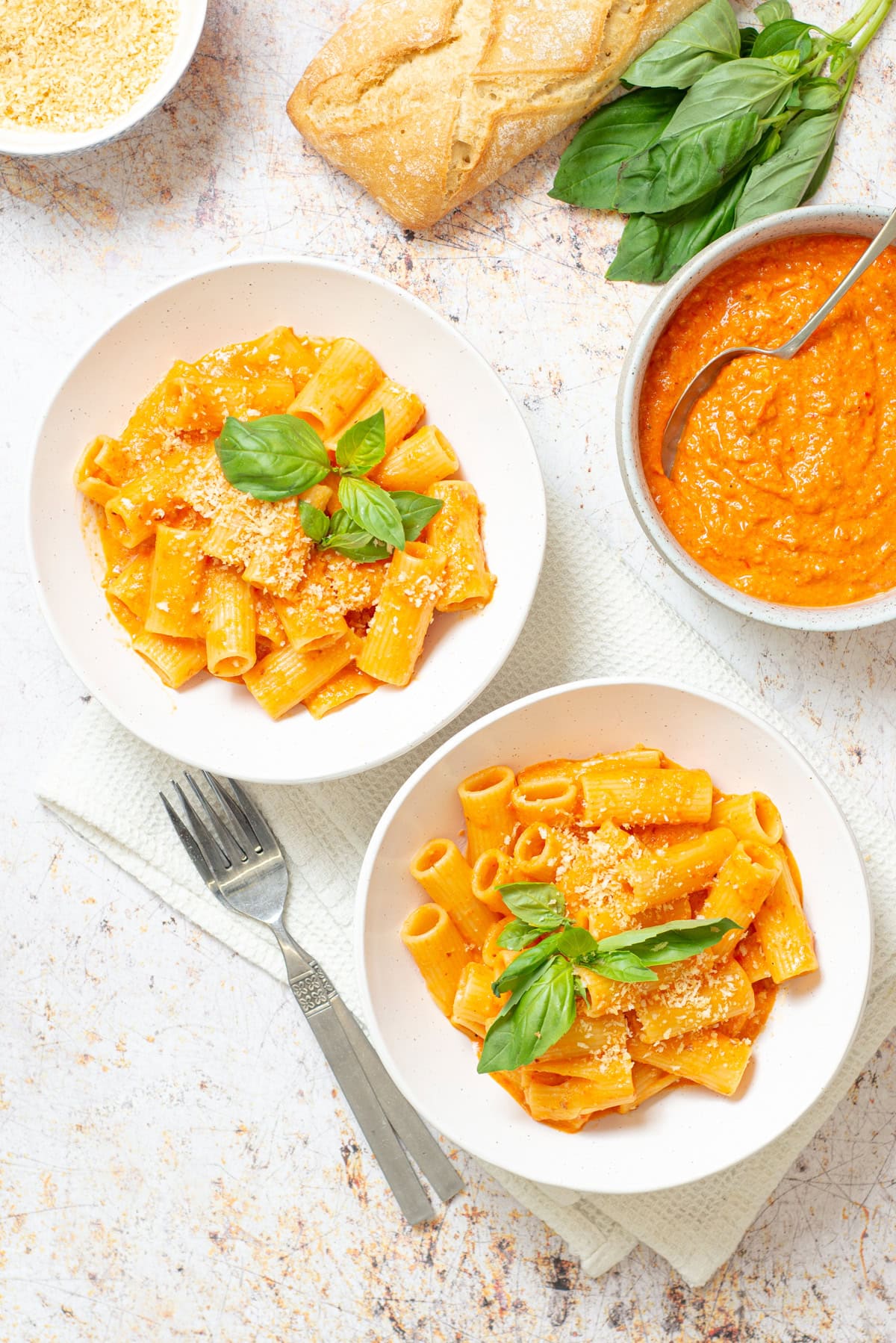 Overhead image of Romesco pasta served with basil and roasted red pepper sauce.