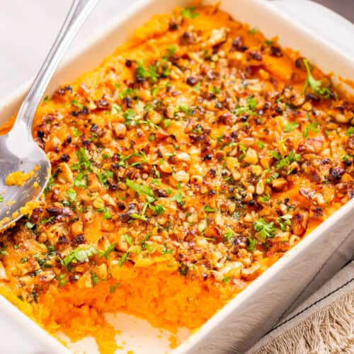 Close up image of savory sweet casserole with spoon on top
