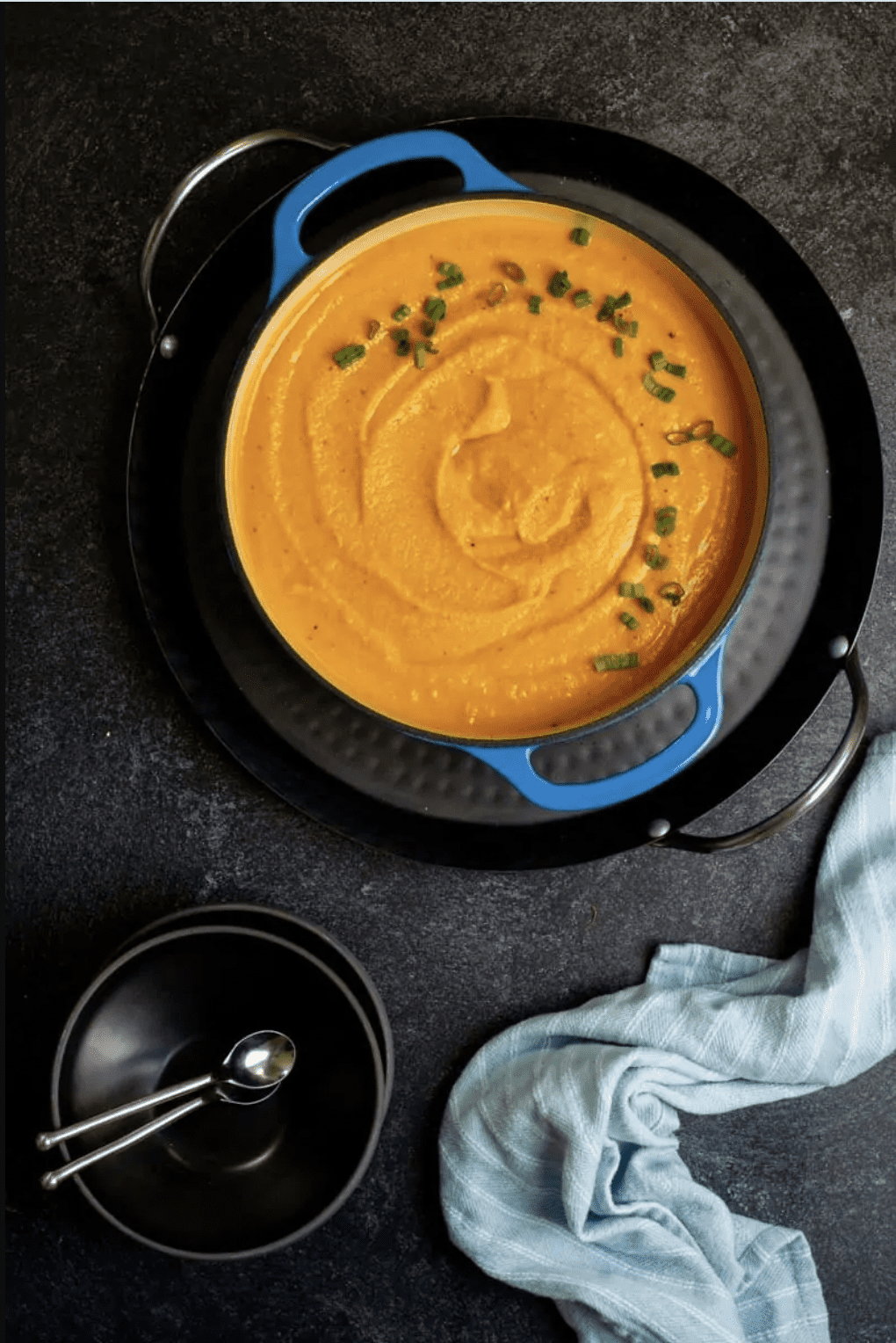 An overhead view of roasted kabocha squash soup placed in a Dutch oven.