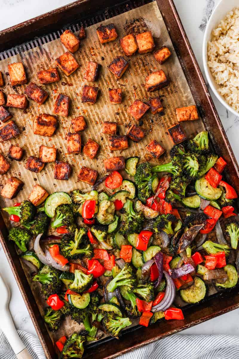 An overhead image of baked tofu and veggies on a sheet pan.