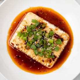 An overhead image of chili garlic silken tofu on a serving bowl.