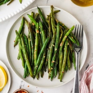 Skillet green beans cooked until lightly browned and served with garlic, red pepper flakes, and lemon.