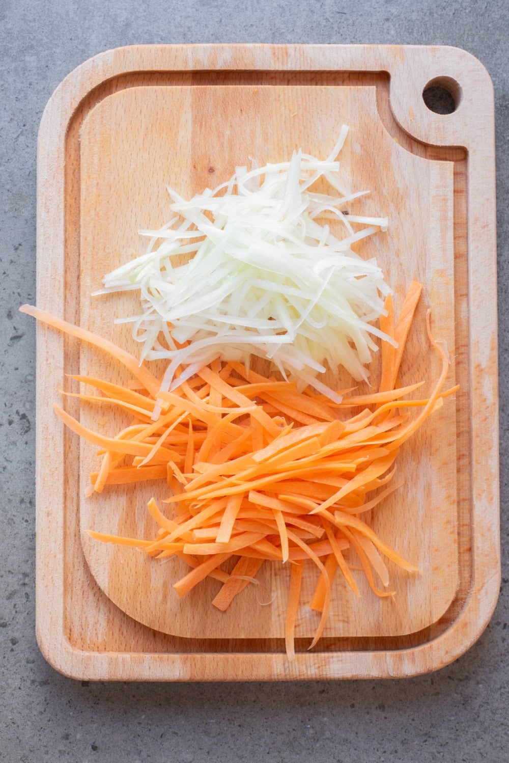 Shredded green papaya and carrot prepared for Thai green papaya salad.