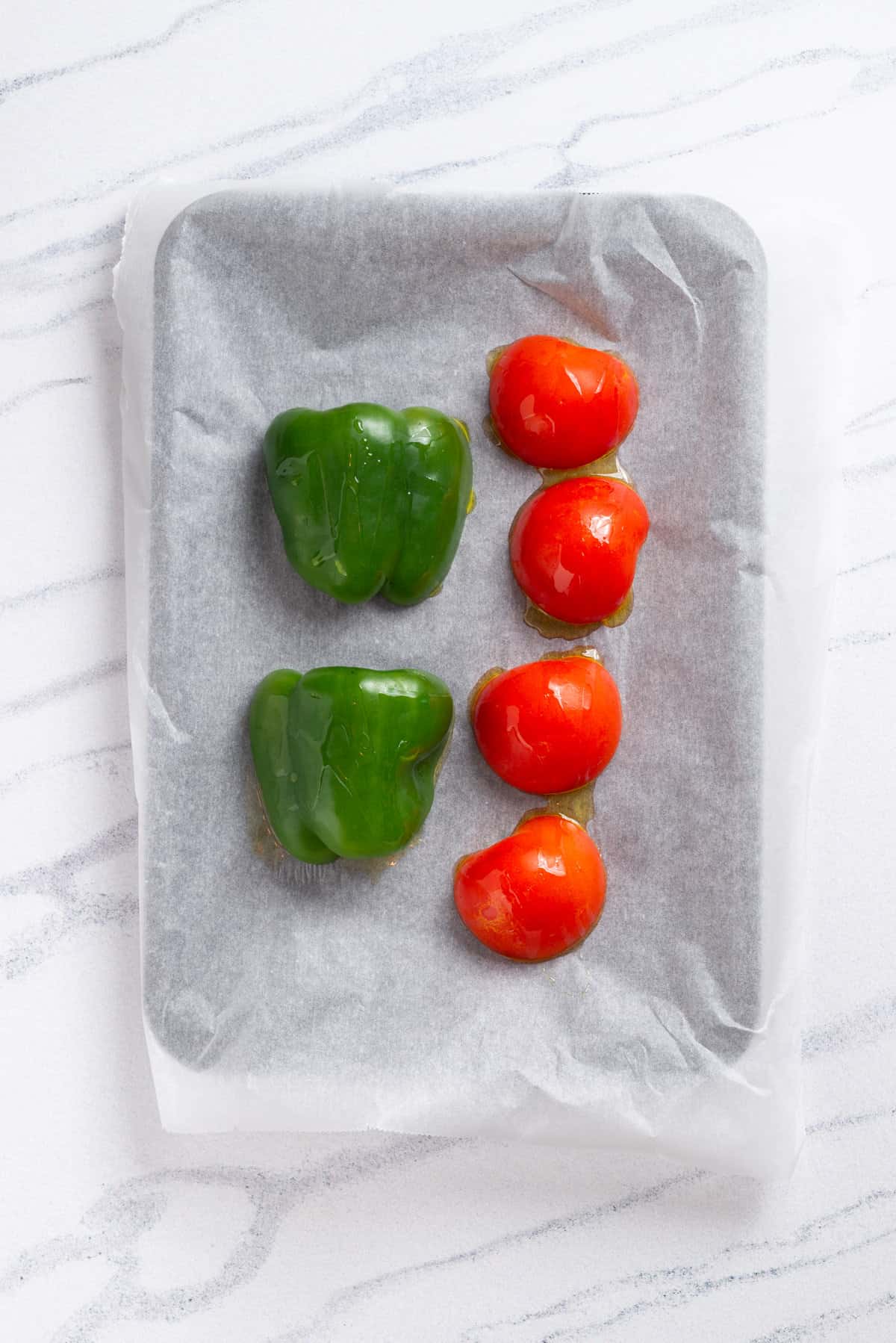 An image of a bell pepper and tomatoes, in a baking pan.
